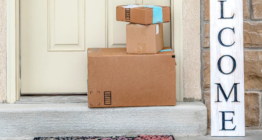 Deliveries on the front porch of a house with a welcome sign in Las Vegas